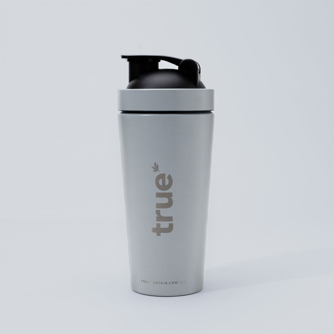 Matte slate stainless steel protein shaker bottle with black flip lid and vertical "true" logo — studio product shot for True Protein (Australia) on white background